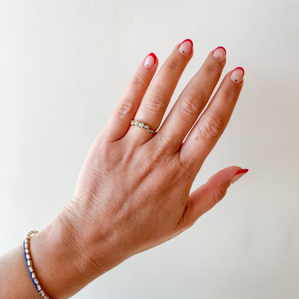 A diamond contour wedding band featuring five graduated size rose cut diamonds set in 18 karat yellow gold.