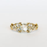 A diamond engagement ring that features a 1 carat rose cut center stone flanked by six rose cut side stones, in a polished 18k yellow gold setting.