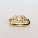 A diamond engagement ring that features a 1 carat rose cut center stone flanked by six rose cut side stones, in a polished 18k yellow gold setting.
