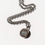 engraved silver and rose gold pendant of ouroboros.