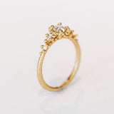 Unique antique cut diamond engagement ring with golden granules, on a gently textured band.