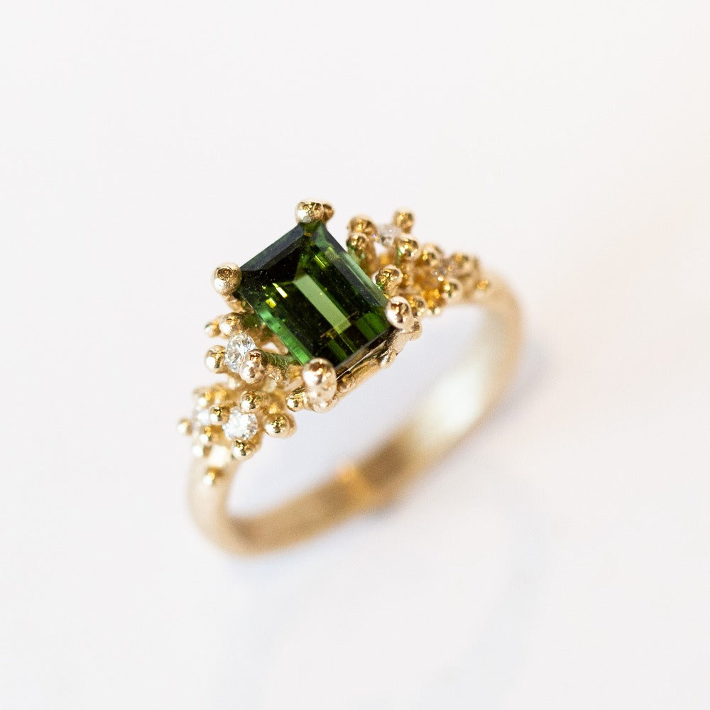 A beautiful deep green tourmaline&nbsp;ring with white&nbsp;diamonds and granules of yellow gold, on a lightly textured band.