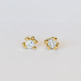 Unique solitaire diamond stud earrings with golden granules in yellow gold.