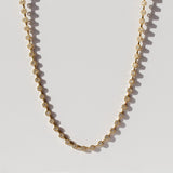 A diamond tennis necklace made up of hexagonal links each set with a small round diamond.