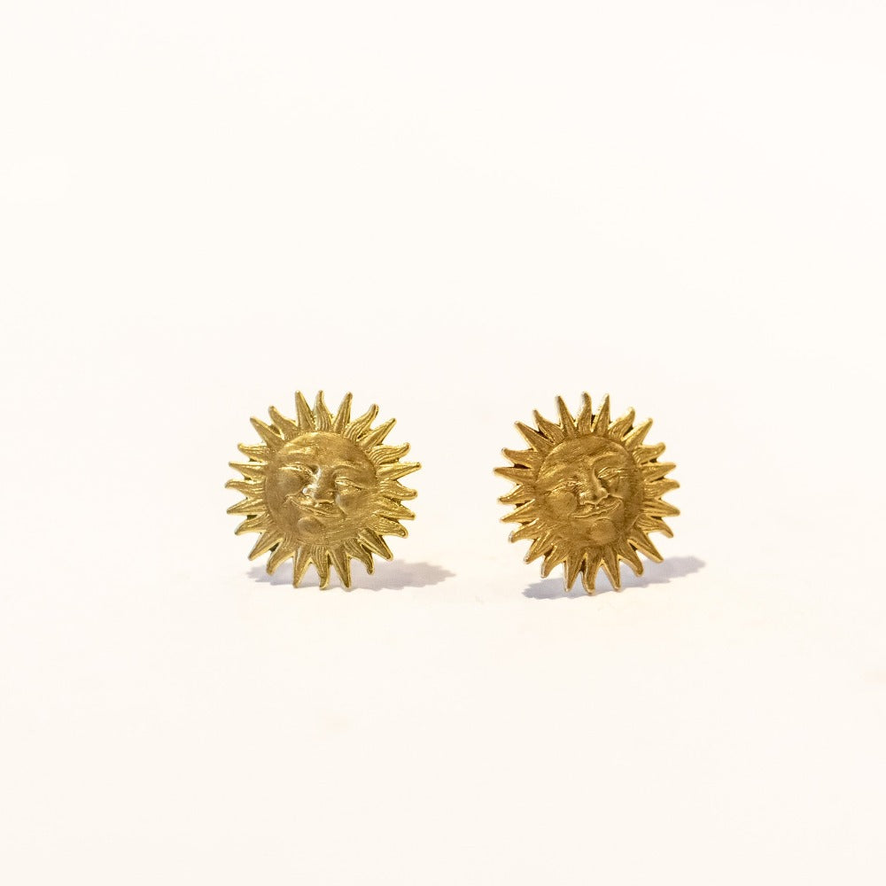 Gold sun shaped stud earrings with faces