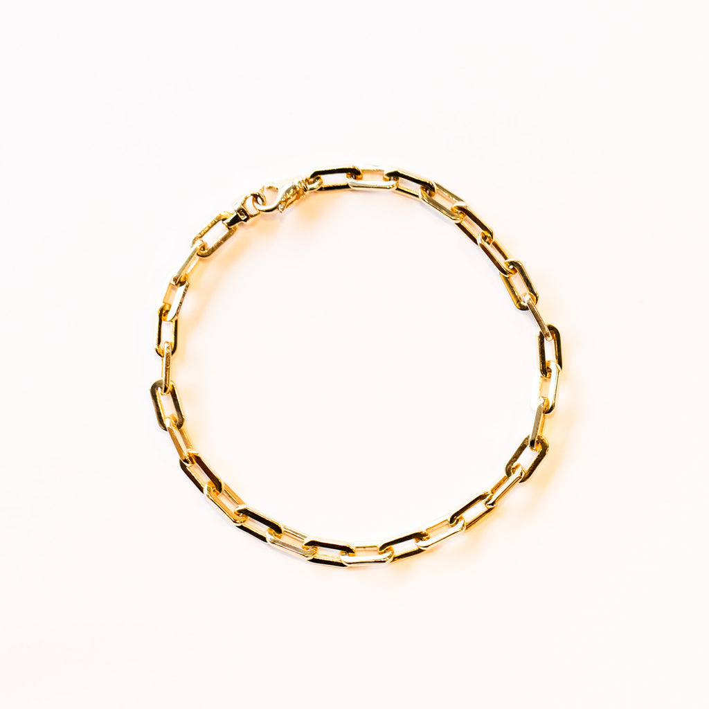 A classic gold chain bracelet with wide wire oval shaped links.