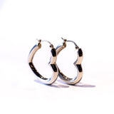 Puffy heart shaped silver hoop earrings.