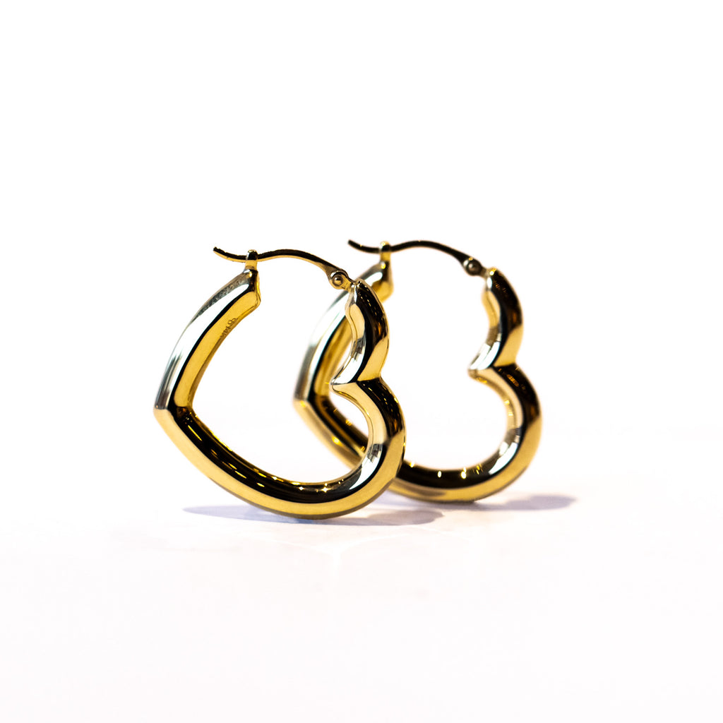 Puffed heart shape gold hoop earrings.