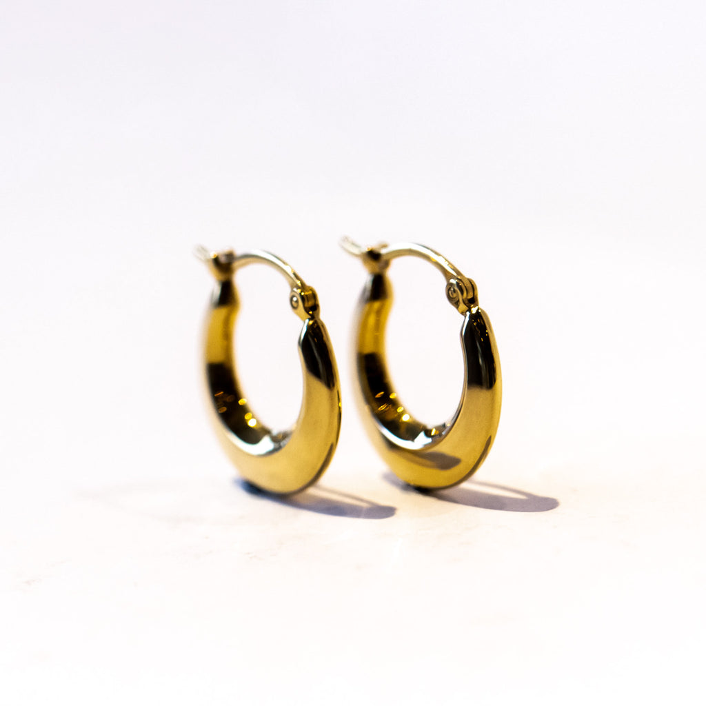 A pair of small gold hoop earrings in a knife-edge design.