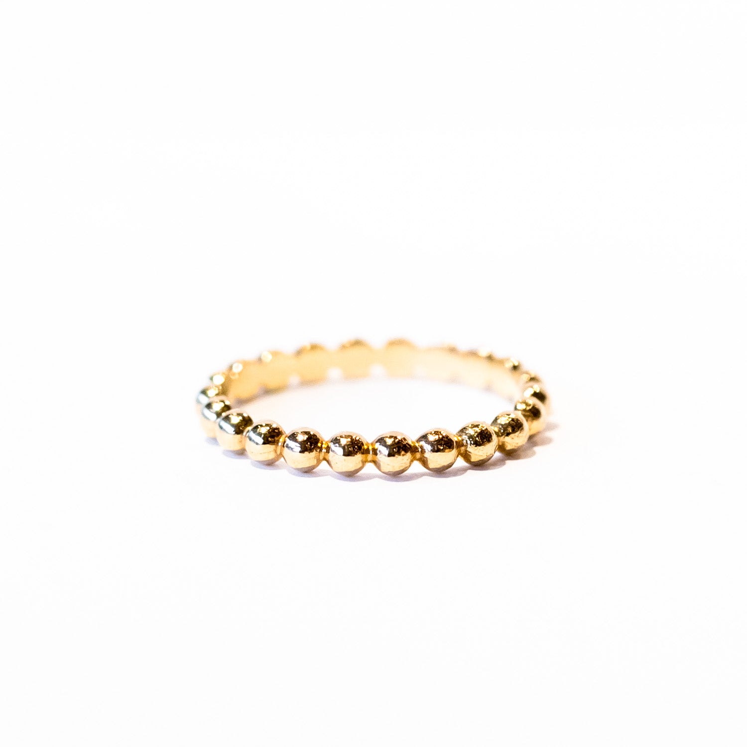 A gold band made up of bubble-shaped balls all the way around.