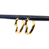 A puffy heart-shaped gold hoop earring.