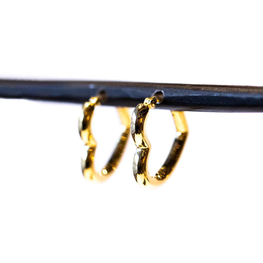 A puffy heart-shaped gold hoop earring.