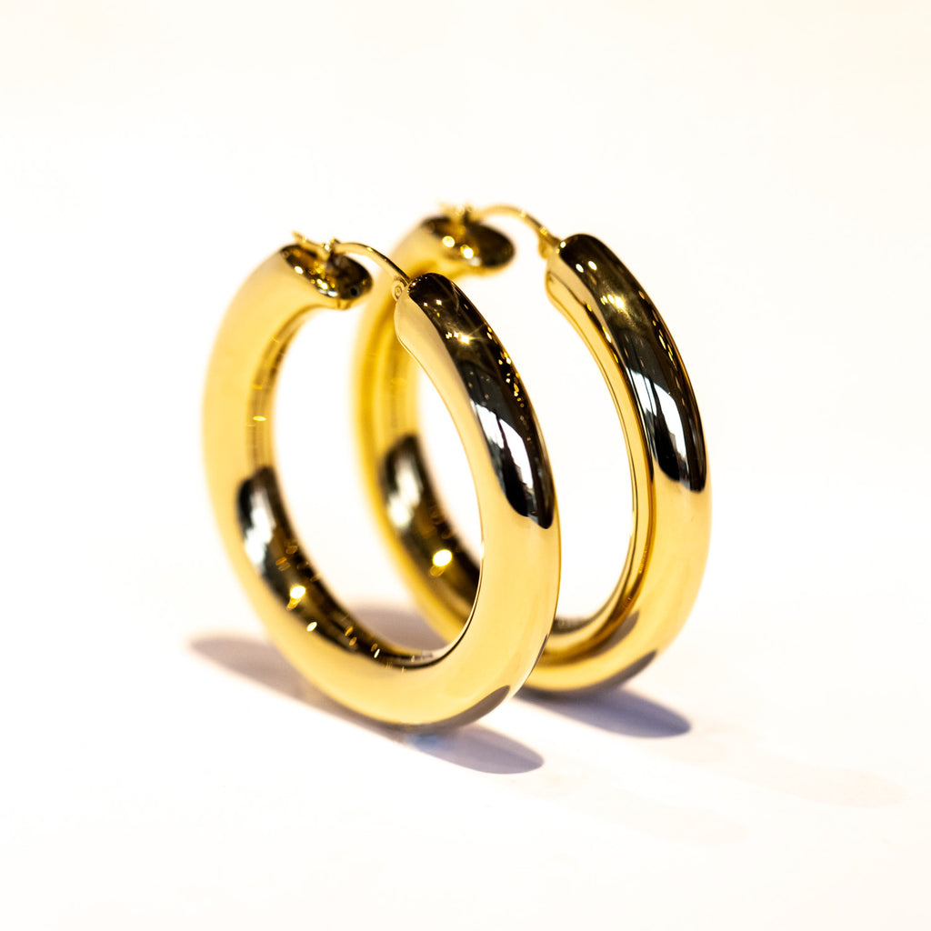 A bold gold, round hoop earring.