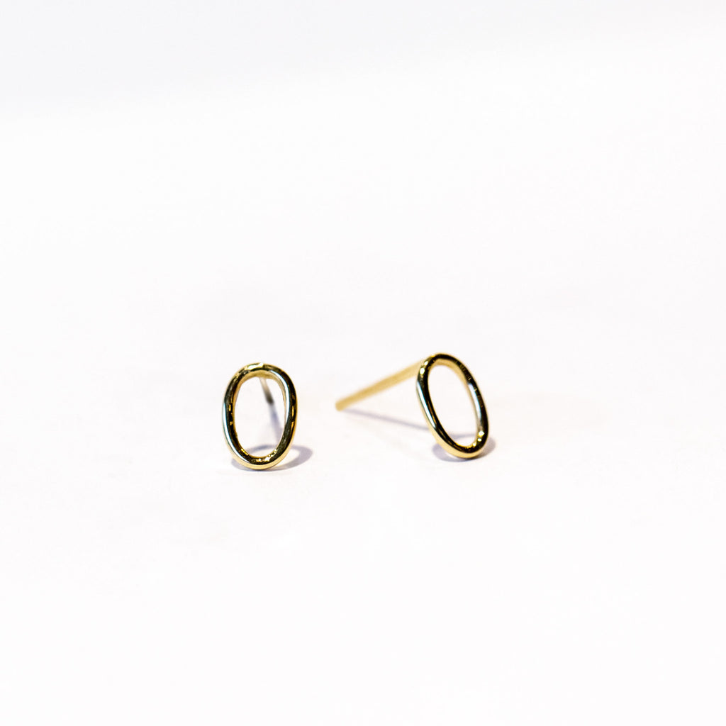 A pair of tiny gold wire, open oval stud earrings