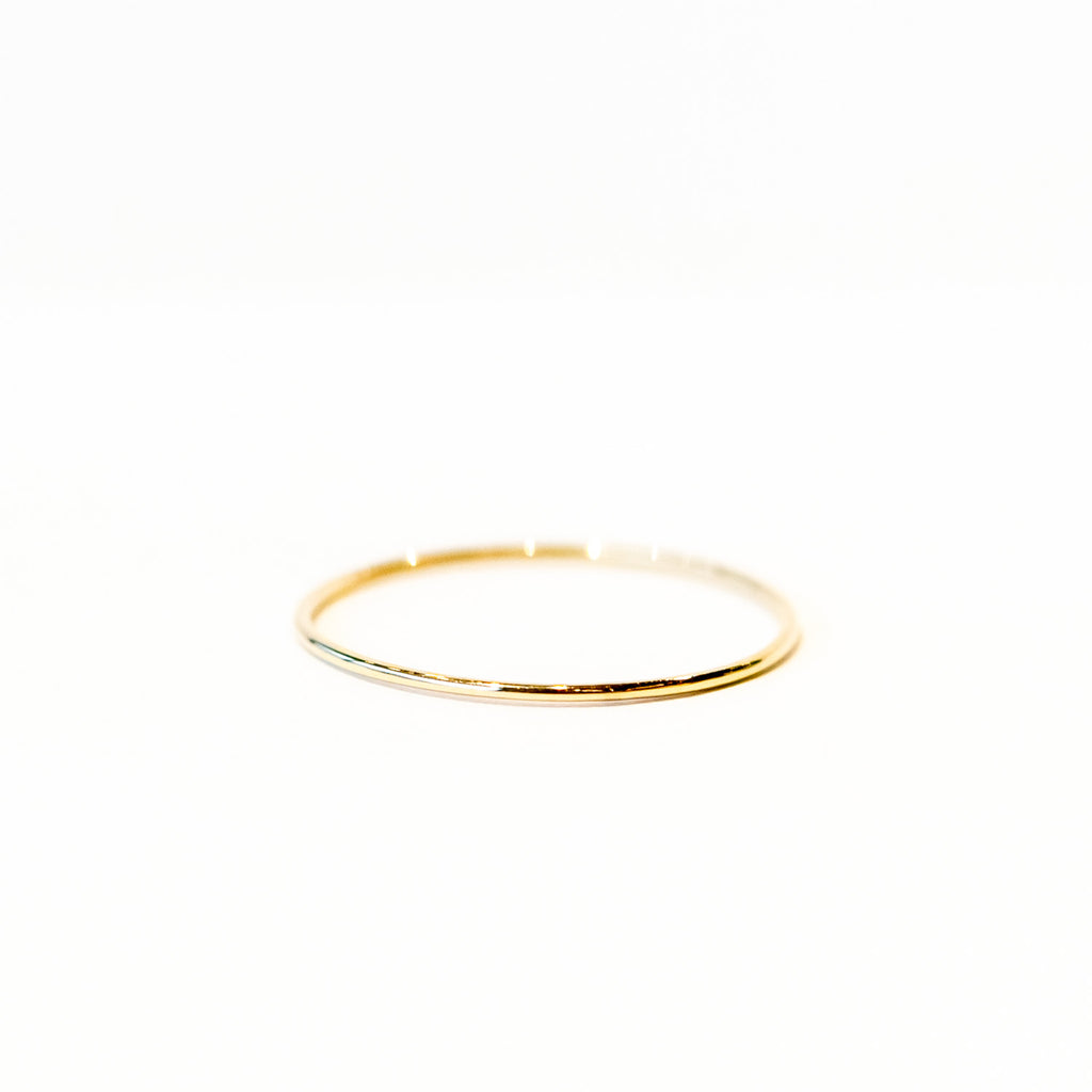 A very thin gold band ring.