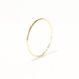 A very thin gold band ring.