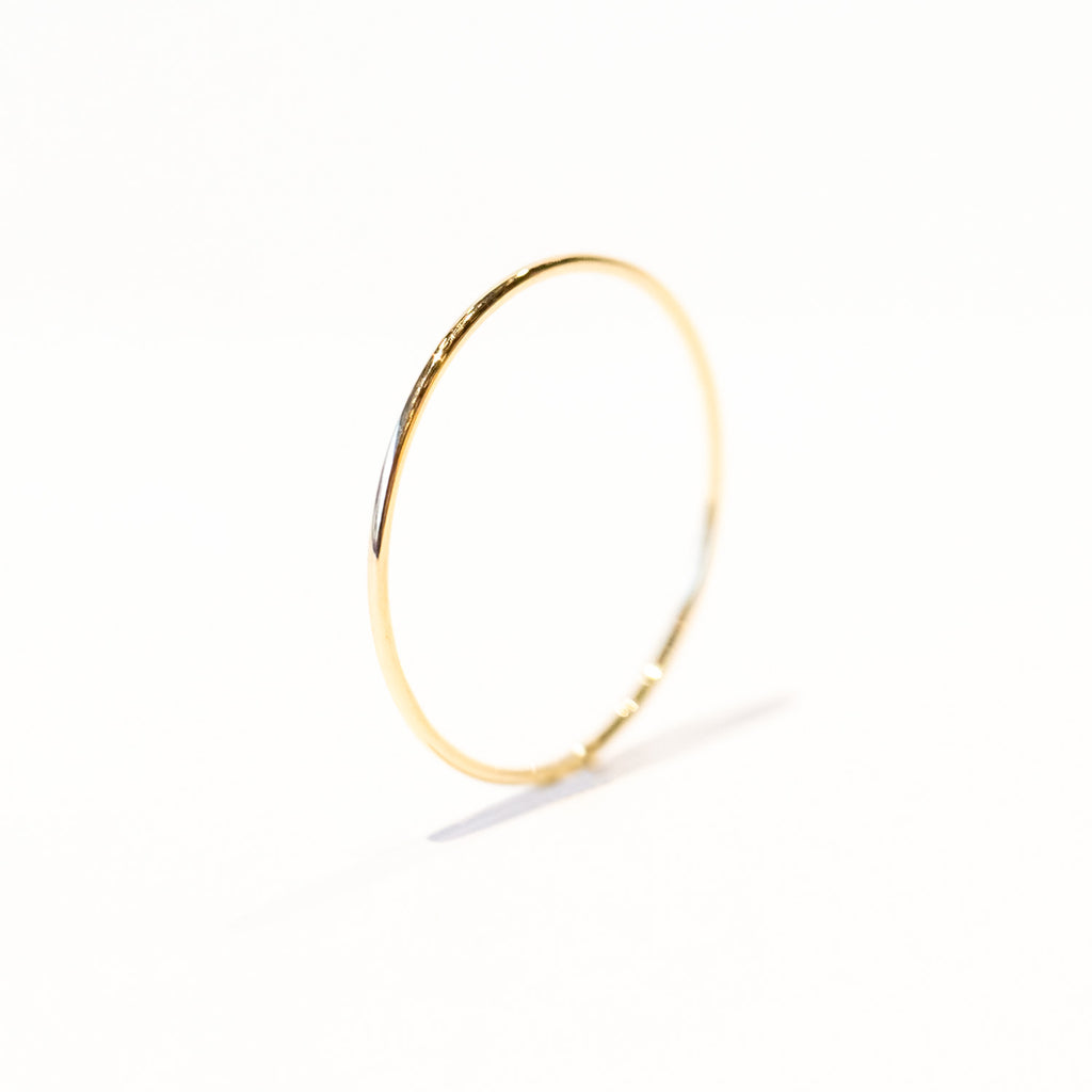A very thin gold band ring.