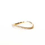 A thin gold wavy band with a row of diamonds along the top.