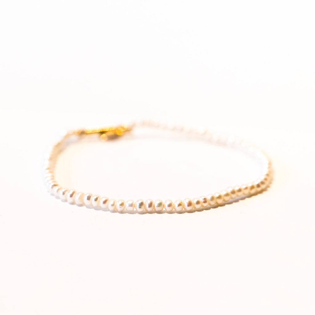 A slim pearl bracelet.