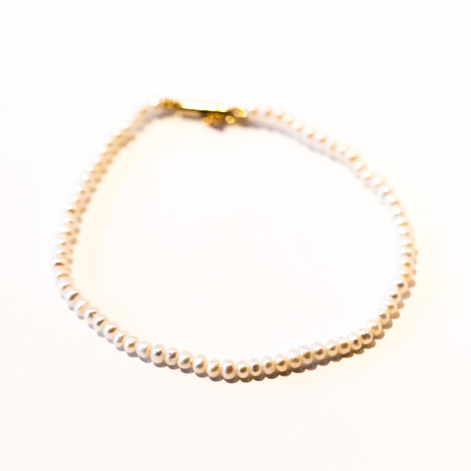 A slim pearl bracelet.