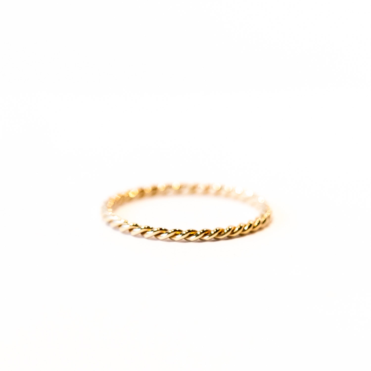 A thin gold band of two twisted wires.