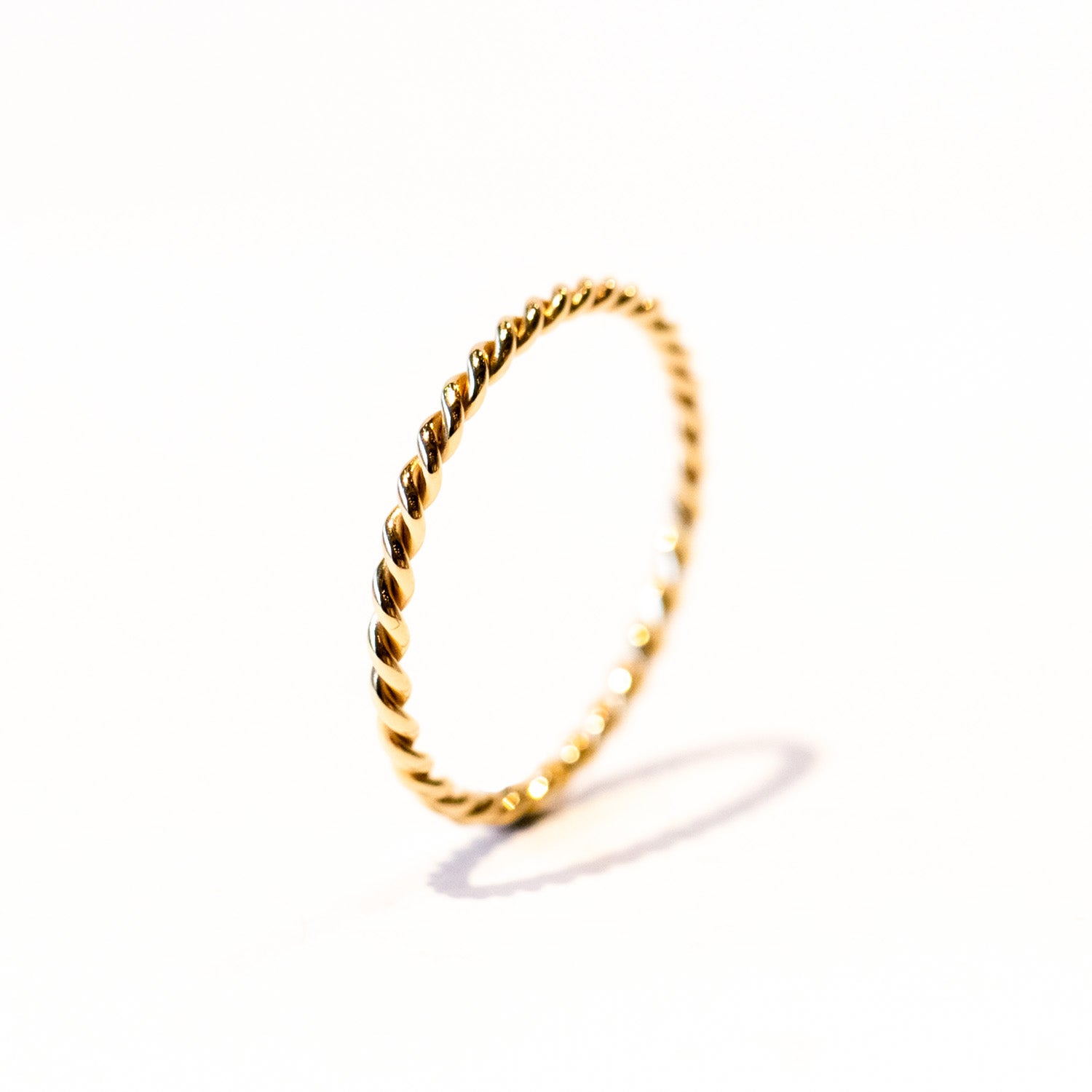 A thin gold band of two twisted wires.