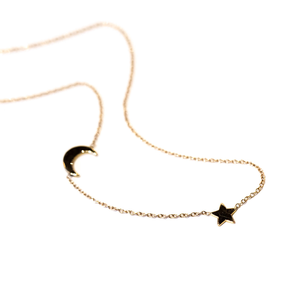 A delicate gold chain necklace with star and moon stations.
