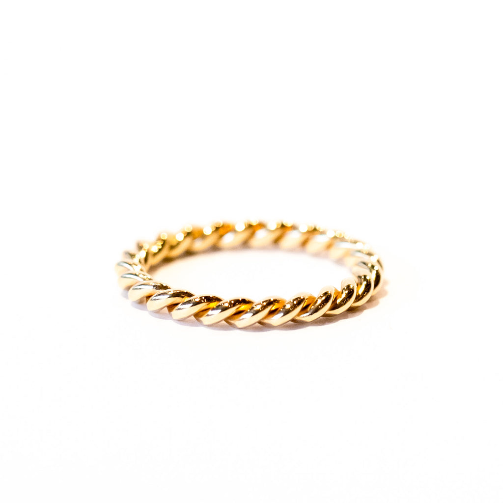A twist-design thin gold band ring.
