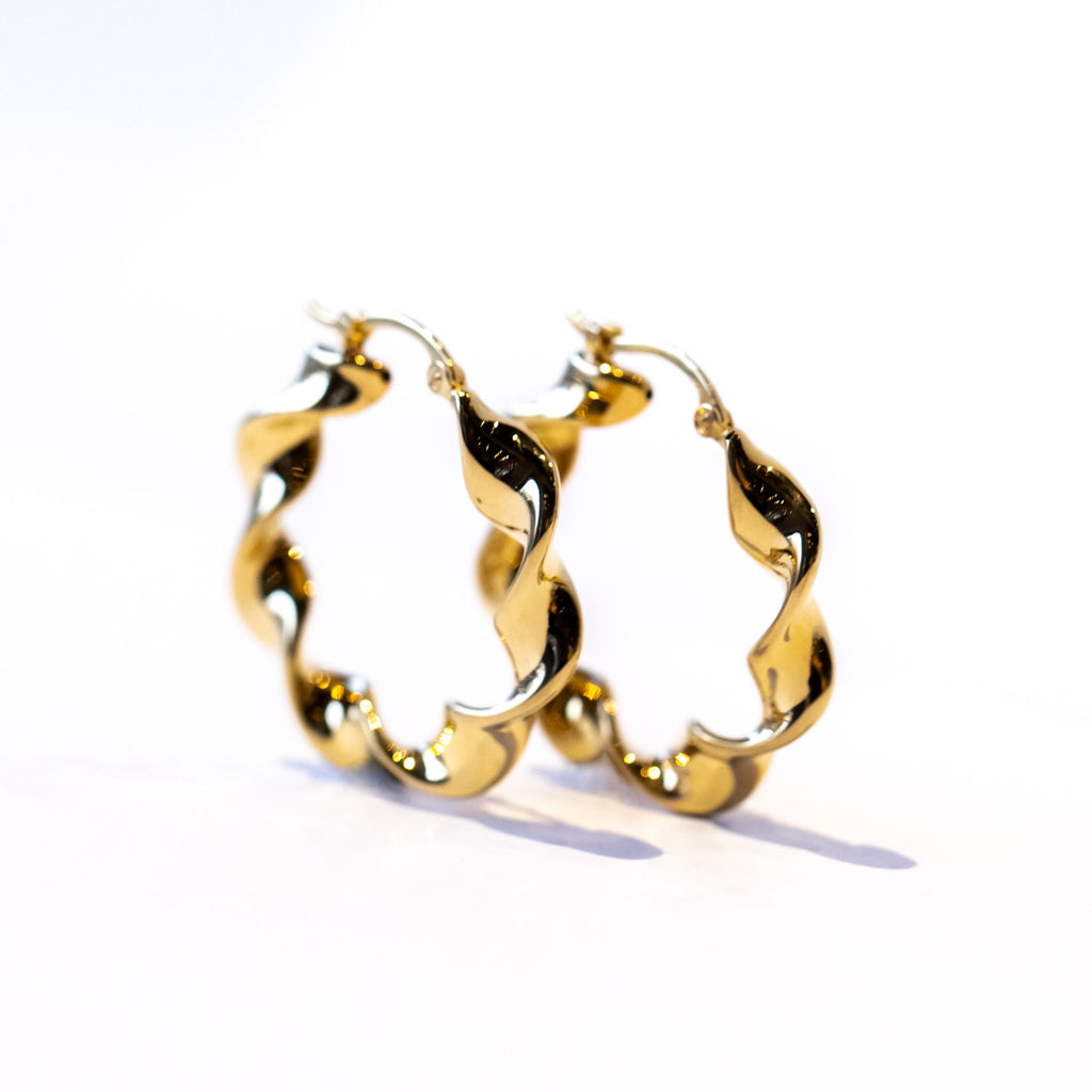 A pair of twist design gold hoop earrings.