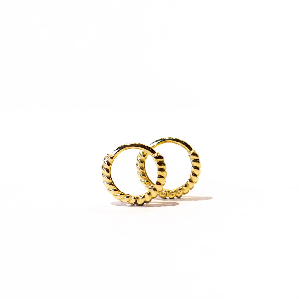 A pair of small gold twist design hoop earrings.
