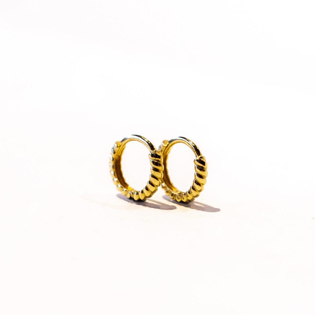 A pair of small gold twist design hoop earrings.