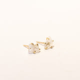 Asymmetrical, rough faceted moonstone stud earrings in yellow gold.