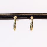 Small, textured yellow gold hoop earrings with three small diamonds along the front.
