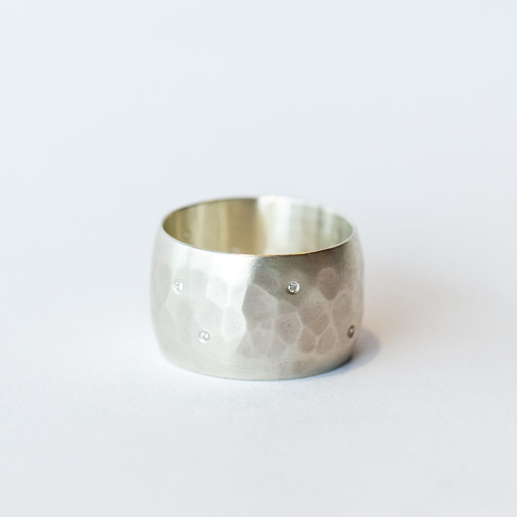 wide hammered sterling silver band with scattered white diamonds flush set