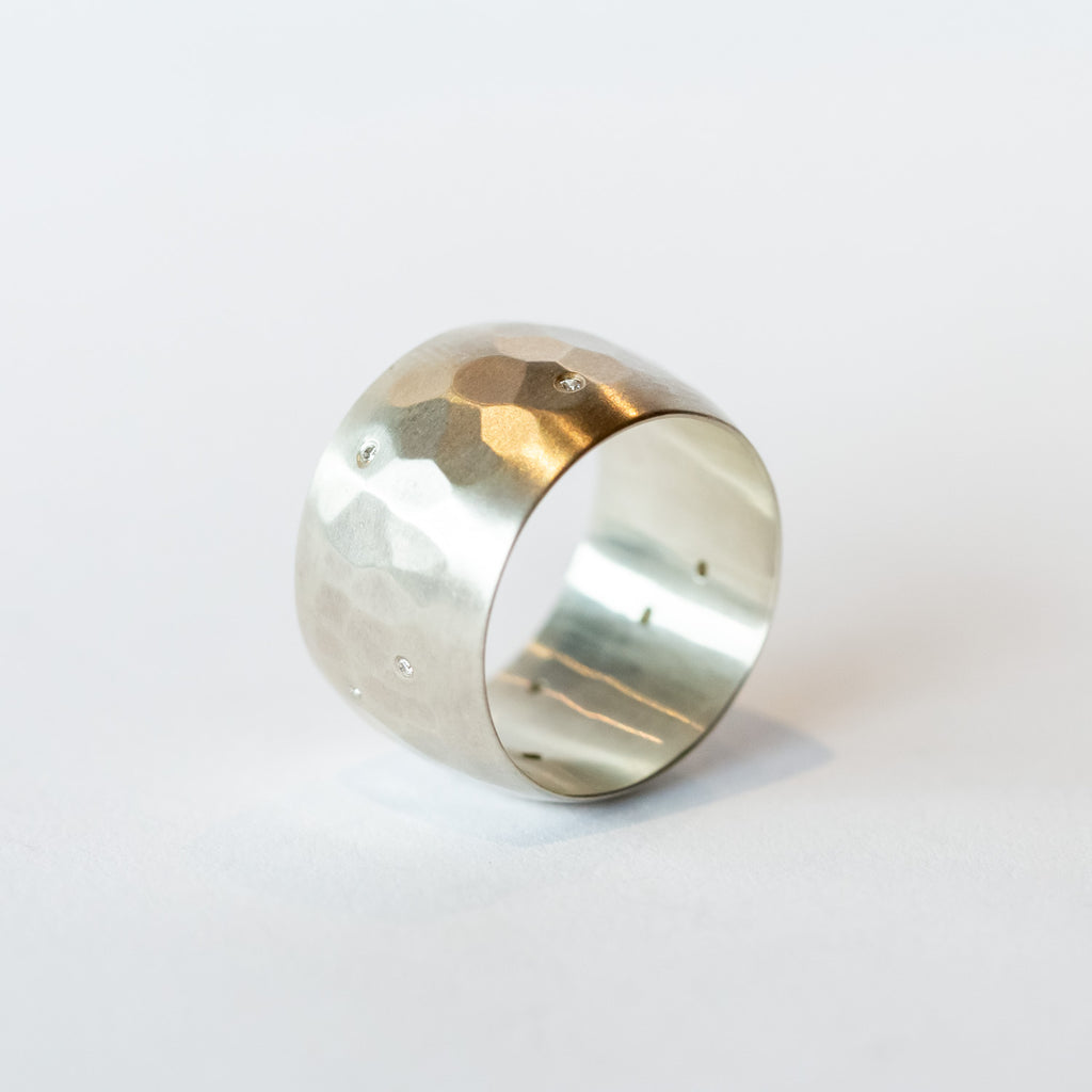 wide hammered sterling silver band with scattered white diamonds flush set