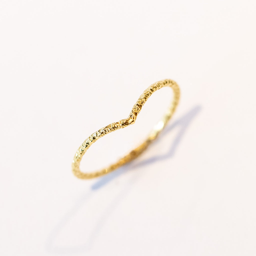Thin hammered 18k gold contour band with hammered detail
