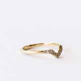 Thin yellow gold contour band with diamonds on the top.