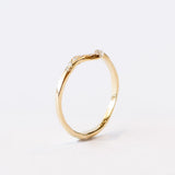 Thin yellow gold contour band with diamonds on the top.