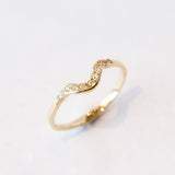 Thin yellow gold contour band with diamonds on the top.