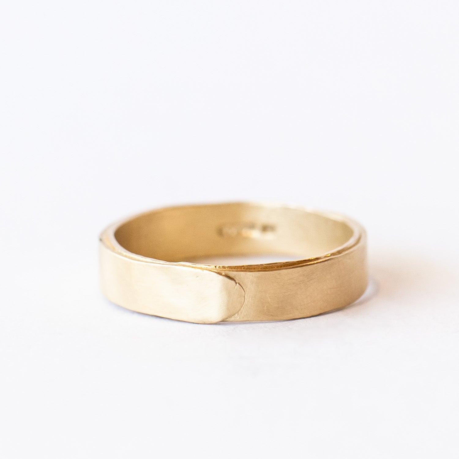 A wide men's wedding band with a wrapped effect in a lightly textured matte finish.