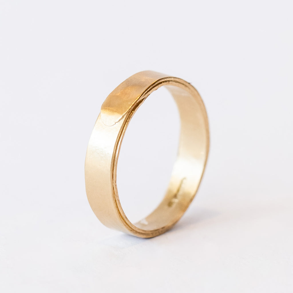 A wide men's wedding band with a wrapped effect in a lightly textured matte finish.