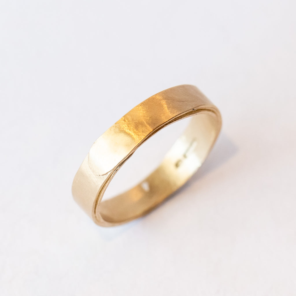 A wide men's wedding band with a wrapped effect in a lightly textured matte finish.