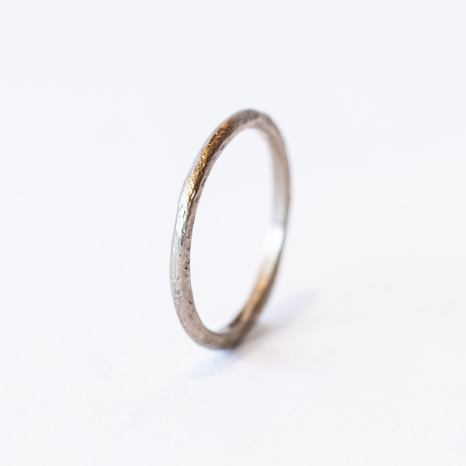 A classic narrow ladies' wedding band with an organic textured finish.