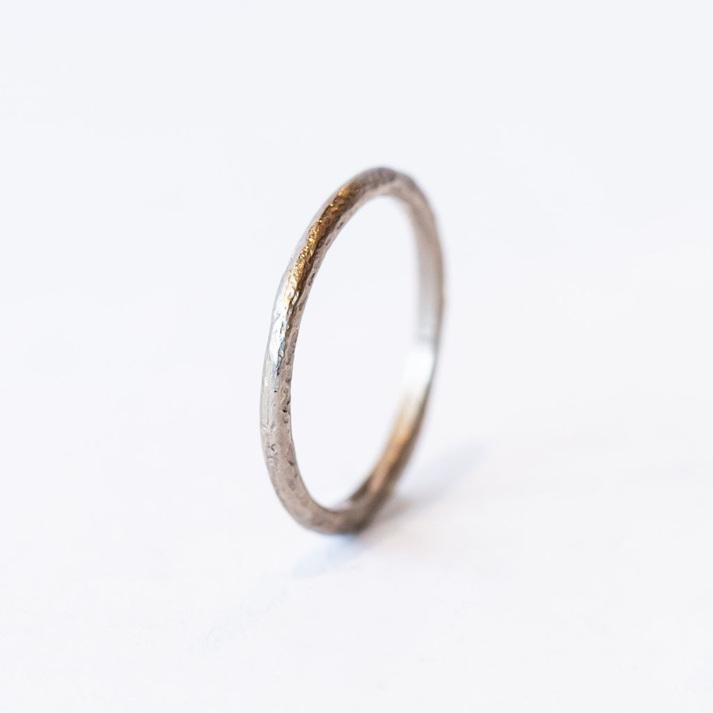 A classic narrow ladies' wedding band with an organic textured finish.
