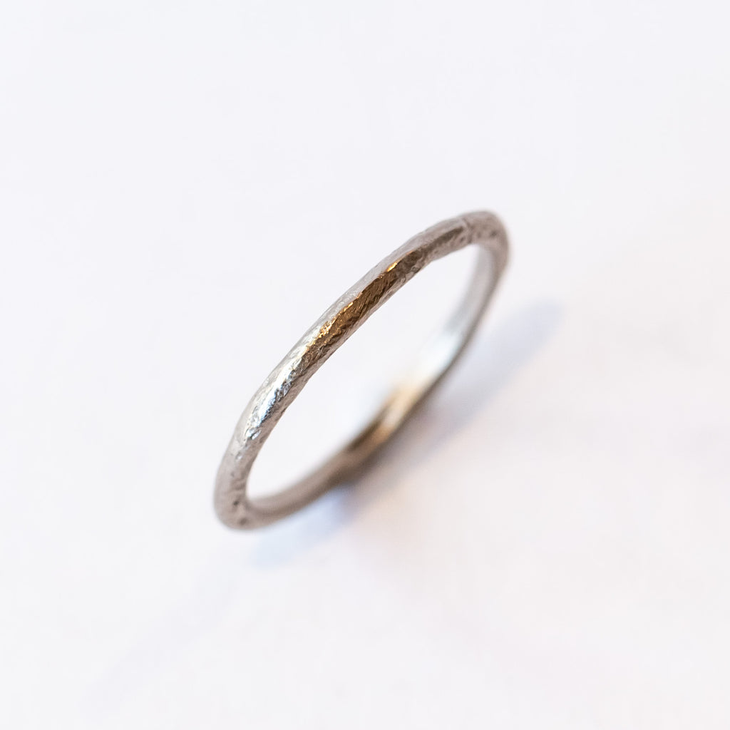 A classic narrow ladies' wedding band with an organic textured finish.