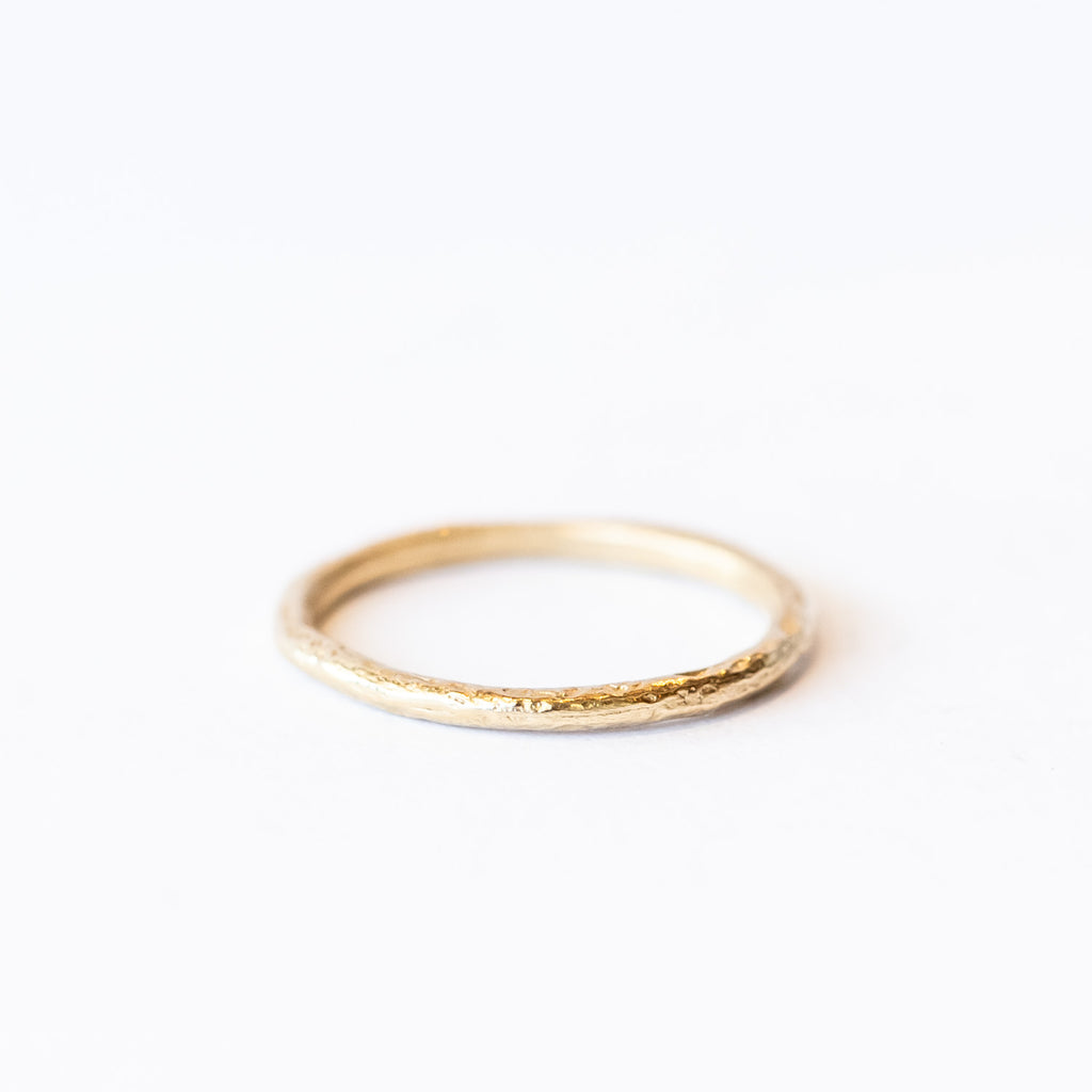A classic narrow ladies' wedding band with an organic textured finish.
