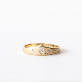 A yellow gold tiara-shaped band set with three marquise diamonds.