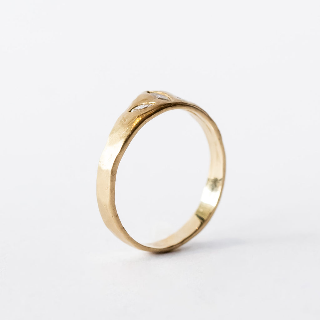 A yellow gold tiara-shaped band set with three marquise diamonds.