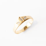 A yellow gold tiara-shaped band set with three marquise diamonds.