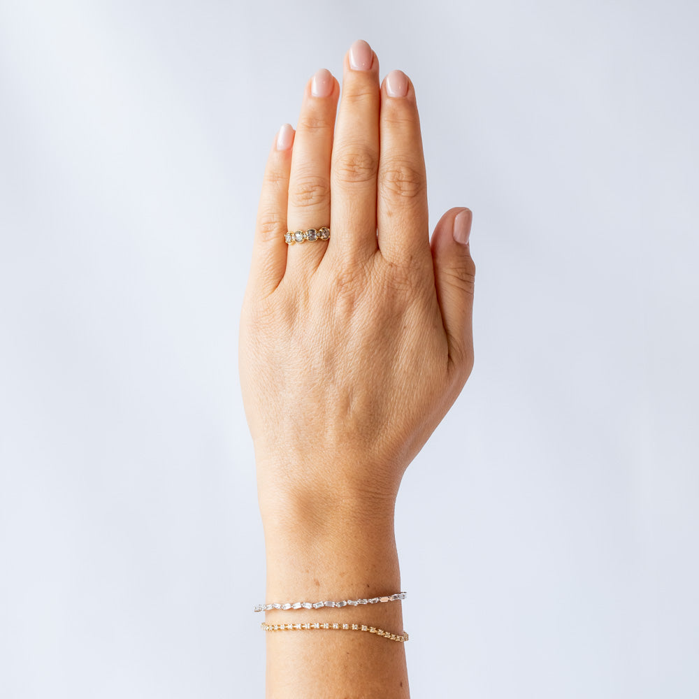 Four rose cut salt and pepper diamonds are set into a yellow gold band with beaded edge details. On hand.